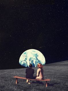 two people sitting on a bench looking at the earth