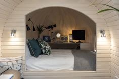 a bedroom with white walls and wood paneling