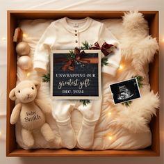 a baby's first christmas gift set in a box with teddy bear and other items