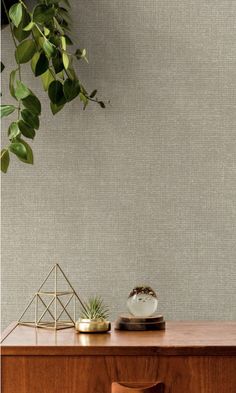 a wooden table topped with a plant next to a wall