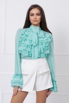 "This is the perfect shirt to add to your wardrobe! It's a versatile piece that can be dressed up or down. The mock-neck and ruffles give it a touch of elegance, while the mint color is unique and eye-catching. The shirt is also extremely comfortable and sheer, making it a great option for layering. Add this shirt to your wardrobe and enjoy the endless possibilities! MODEL INFO: Our model is 5'8 (173 cm.) and wearing size S. SIZES: XS, S, M, L, XL and Custom Size (Please, check the measurements Chic Long Sleeve Shirt For Spring, Chic Green Workwear Shirt, Chic Green Shirt For Work, Collared Ruffle Tops For Office, Elegant Green Shirt For Spring, Trendy Party Shirt For Spring, Elegant Green Spring Shirt, Chic Long Sleeve Shirt For Party, Trendy Ruffled Collar Tops For Spring