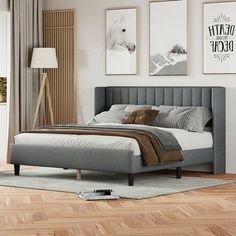 a bed sitting in a bedroom on top of a hard wood floor