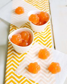 small white bowls filled with jelly candies on top of a yellow and white towel