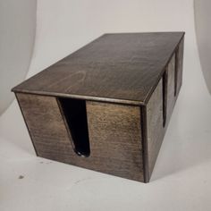 a wooden box with two holes in it