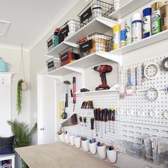 there are many crafting supplies on the shelves in this room, including scissors and other tools