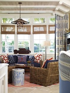 a living room filled with furniture and lots of windows