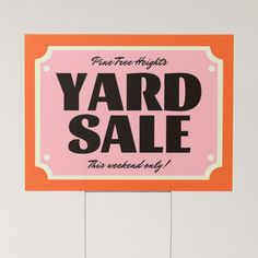 a yard sale sign is hanging on the wall