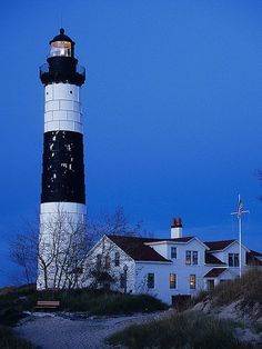 the lighthouse is lit up at night with its lights on