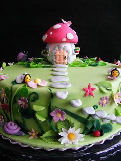 a green cake decorated with flowers and a mushroom on top is featured in an instagram post