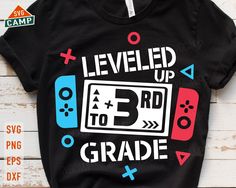 a t - shirt that says level up 3rd grade with video game controllers on it