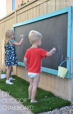 two young children writing on a chalkboard in front of a fence with the caption how to make an outdoor chalkboard