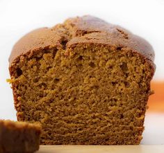 a loaf of pumpkin bread sitting on top of a wooden cutting board