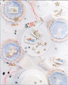 a table topped with plates and desserts covered in confetti