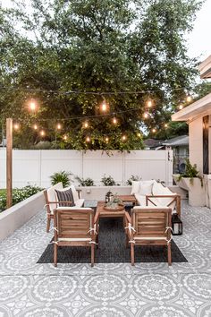 an outdoor patio with seating and string lights