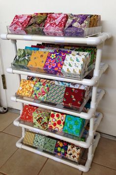 a white shelf filled with lots of different colored wrappings on top of each other