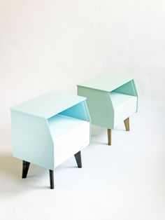 two blue and white side tables sitting next to each other