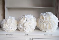 three bridal bouquets sitting on top of a white dresser