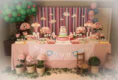 a table topped with lots of cake and cupcakes on top of a table