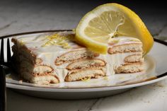 a slice of lemon cake on a plate with a fork