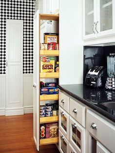 an organized pantry in the corner of a kitchen with black and white checkered wallpaper