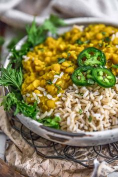 a bowl filled with rice and vegetables on top of a table