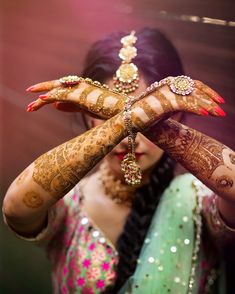 the bride is getting ready to show off her mehndi and jewelry on her wedding day