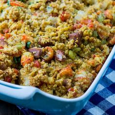 a casserole dish with meat and vegetables in it on a checkered table cloth