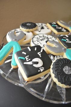 decorated cookies are arranged on a clear platter