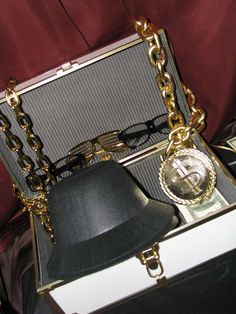 an open briefcase with a bell and chain around it