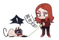 a woman with red hair is playing with a cat in front of a black bat