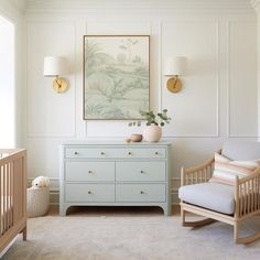 a baby's room with two cribs and a painting on the wall