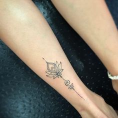 a woman's foot with a flower tattoo on it