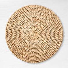 a round woven placemat on a white background