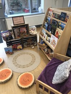 there are bookshelves and beds in the children's playroom with toys on the floor