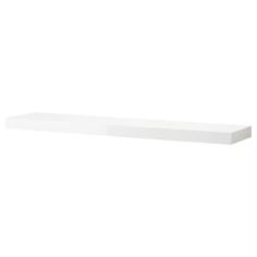 a white shelf sitting on top of a wall