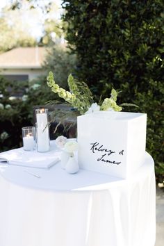 a white table topped with a vase filled with flowers