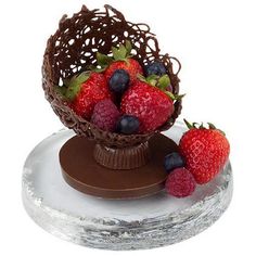 a chocolate cake with strawberries and blueberries on top