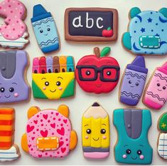 decorated cookies are arranged in the shape of school supplies