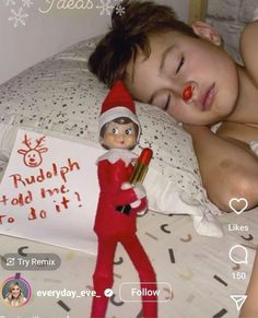 an elf is sleeping on the bed with a sign