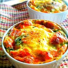 two bowls filled with food sitting on top of a checkered table cloth next to each other