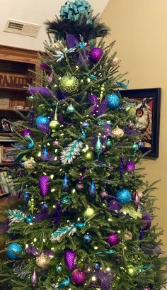 a decorated christmas tree with purple and blue ornaments