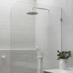 a bathroom with a shower head, sink and mirror