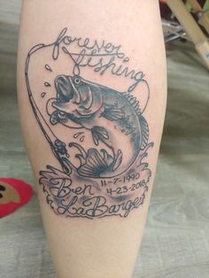 a tattoo on the leg of a person with a fish and fishing rod in it