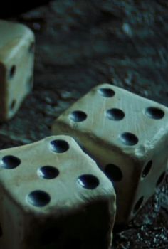 two dices sitting on the ground next to each other with holes cut in them