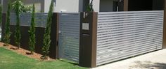 a modern fence in front of an apartment building