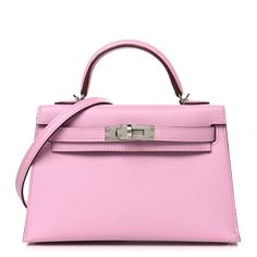 This is an authentic HERMES Epsom Mini Kelly Sellier 20 in Chai, Mauve Sylvestre. This stunning Hermes classic handbag is beautifully crafted in stamped epsom calfskin leather in pink. A single pink rolled leather top handle is secured with silver palladium plated hardware and an optional leather shoulder strap is included. The traditional Kelly turn lock secures the small flap and the interior features a matching brown chevre goatskin leather with a single flat pocket. Pink Leather Handbag, Hermes Kelly Pink, Pink Kelly Bag, Mini Kelly Hermes, Mini Pink Bag, Pink Hermes, Mauve Sylvestre, Pink Kelly, Mini Kelly