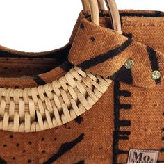 Introducing the Nasika Tote, a stunning handbag crafted from rich mudcloth. This traditional Malian fabric is renowned for its unique texture and cultural significance, making each bag a wearable piece of art. The intricate patterns and earthy tones of the mudcloth create a sophisticated look that's both elegant and eye-catching. With its spacious interior, sturdy cane handles, and inner pocket, this bag is as functional as it is beautiful. Every purchase supports women from low-income weaving c Accra Ghana, Cane Handles, Low Income, Tote Handbag, Mud Cloth, Cultural Heritage, Women Supporting Women, Intricate Patterns, Earthy Tones