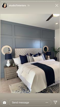 a bedroom with blue walls and white bedding