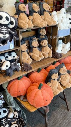 stuffed animals and pumpkins are on display in a store