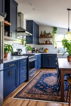 a kitchen with blue cabinets and wooden floors, potted plants on the counter top